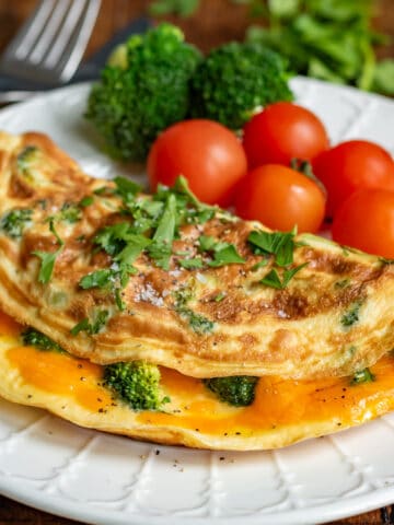 Close up of a broccoli omelet on a plate.