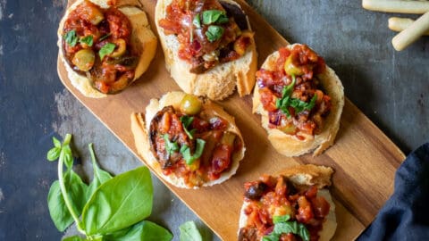 Tray of crostini topped with caponata siciliana.
