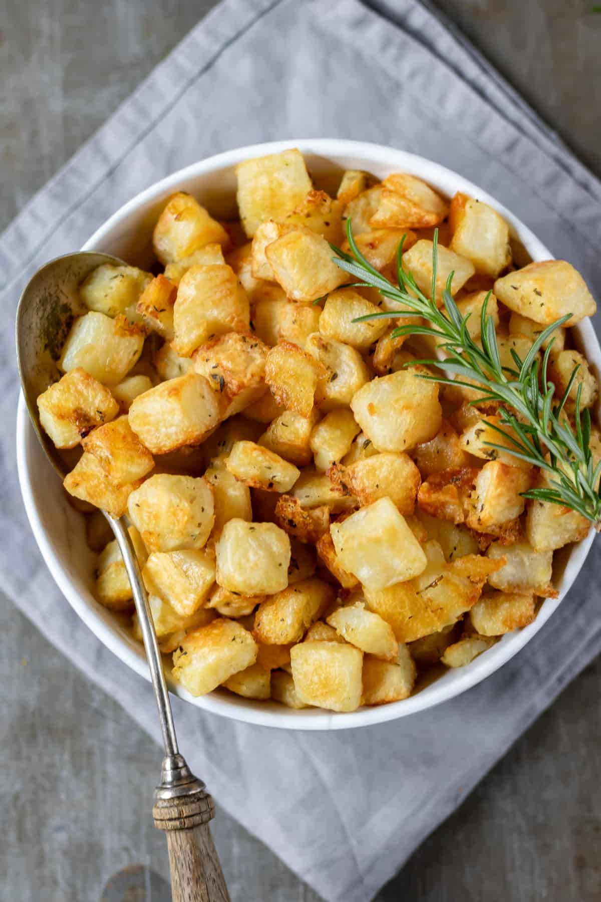 Looking down at a bowl of cubed crispy Parmentier Potatoes.