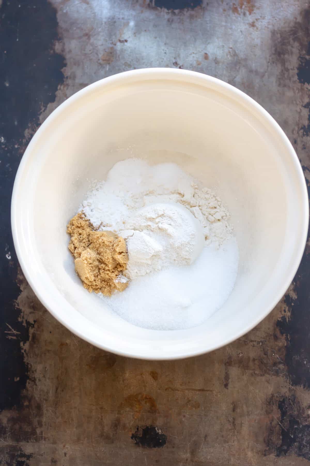 Flour, brown and white sugar and baking powder in a mixing bowl.