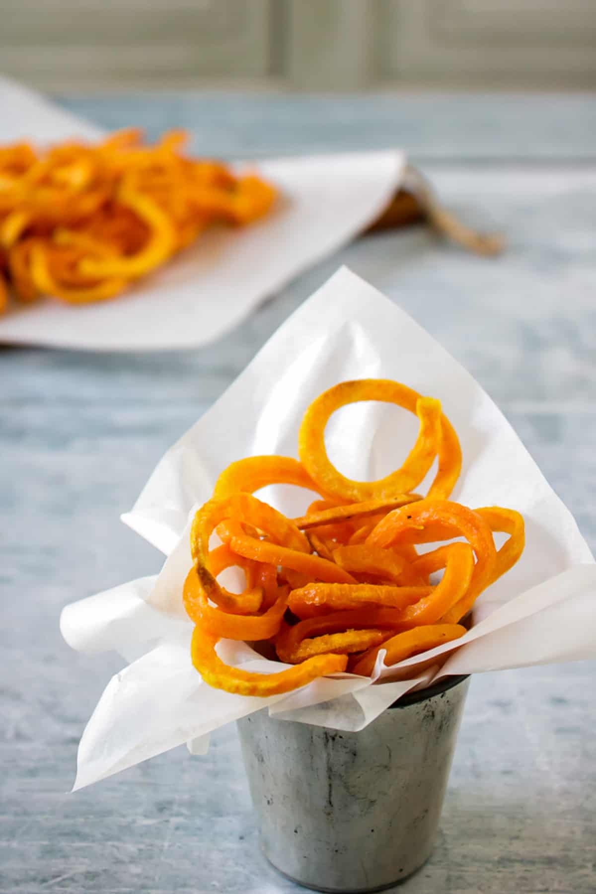 Table with a dish of Spiralized Sweet Potato Fries.