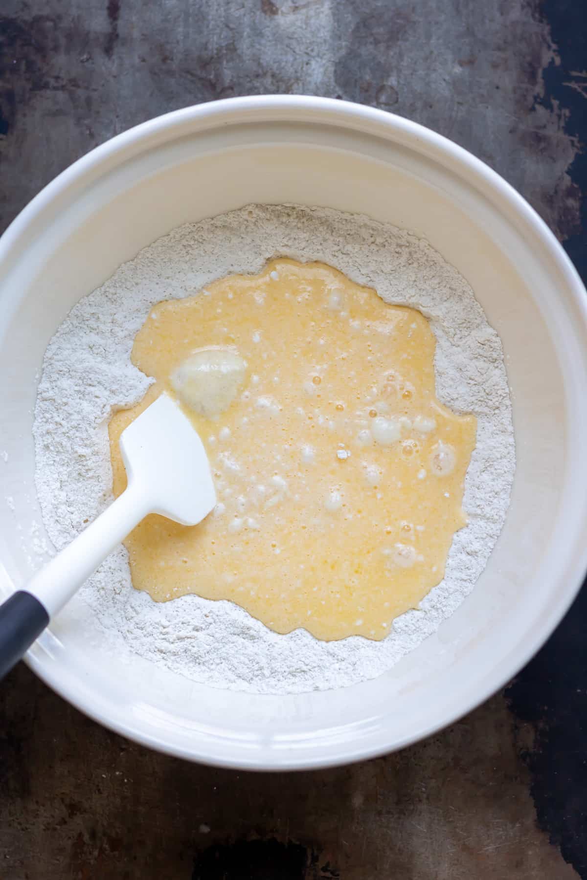 Mixing the wet ingredients into the dry.