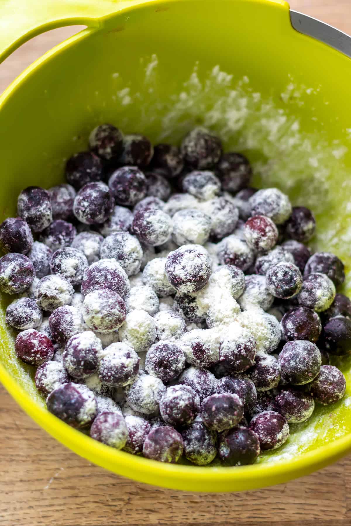 Tossing the blueberries in a little flour.