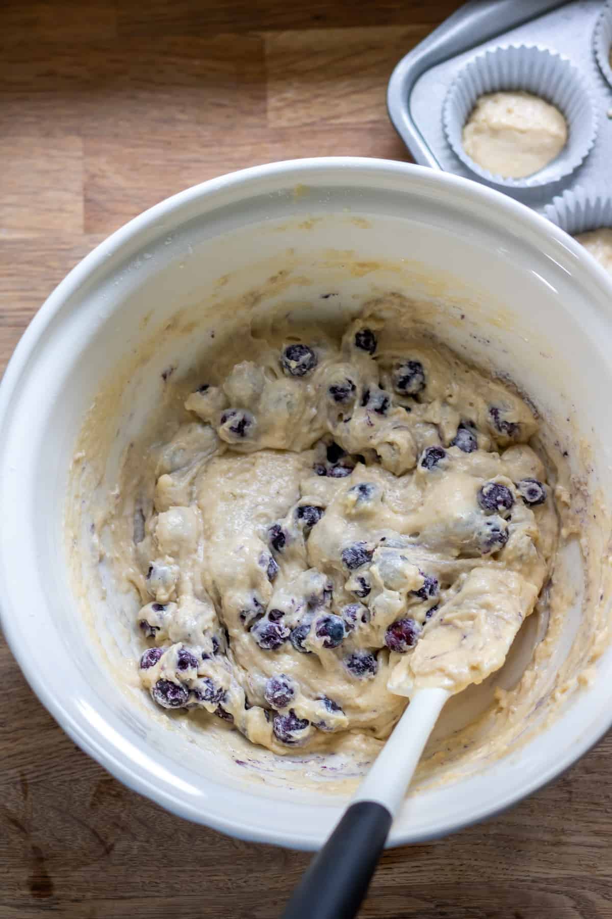 Mixing the blueberries into the batter.