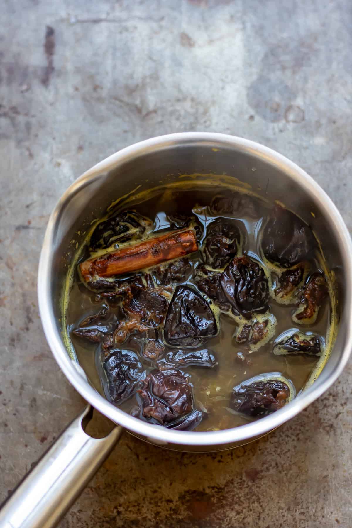 Simmered prunes in orange juice and water.