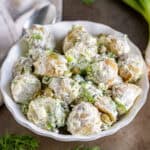 Close up of a bowl of caper potato salad.