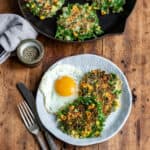 Looking down at a plate of kale fritters and a fried egg.