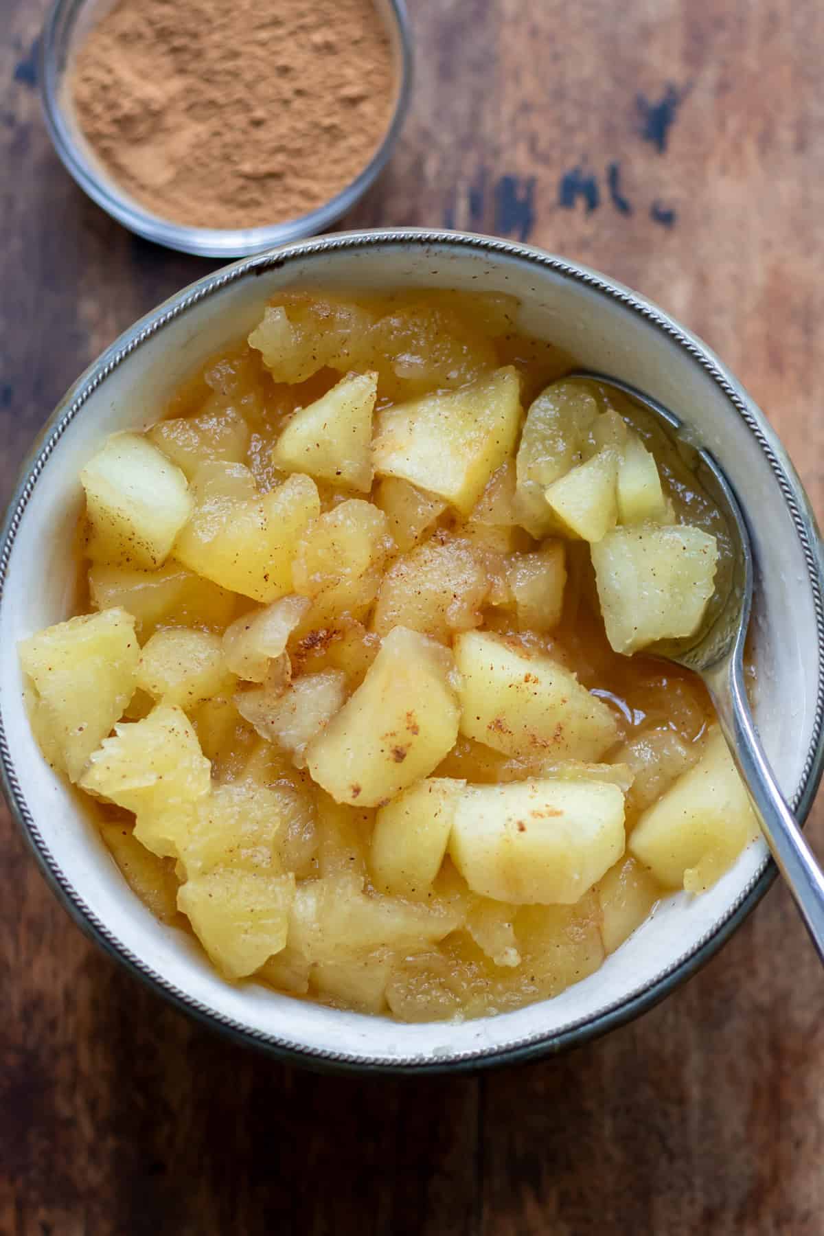 Spoon in a small dish of apple compote.