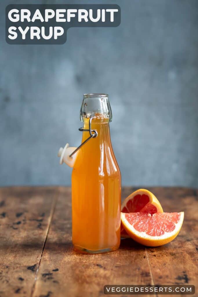 Glass bottle of simple syrup next to slices of grapefruit, with text: Grapefruit Syrup.