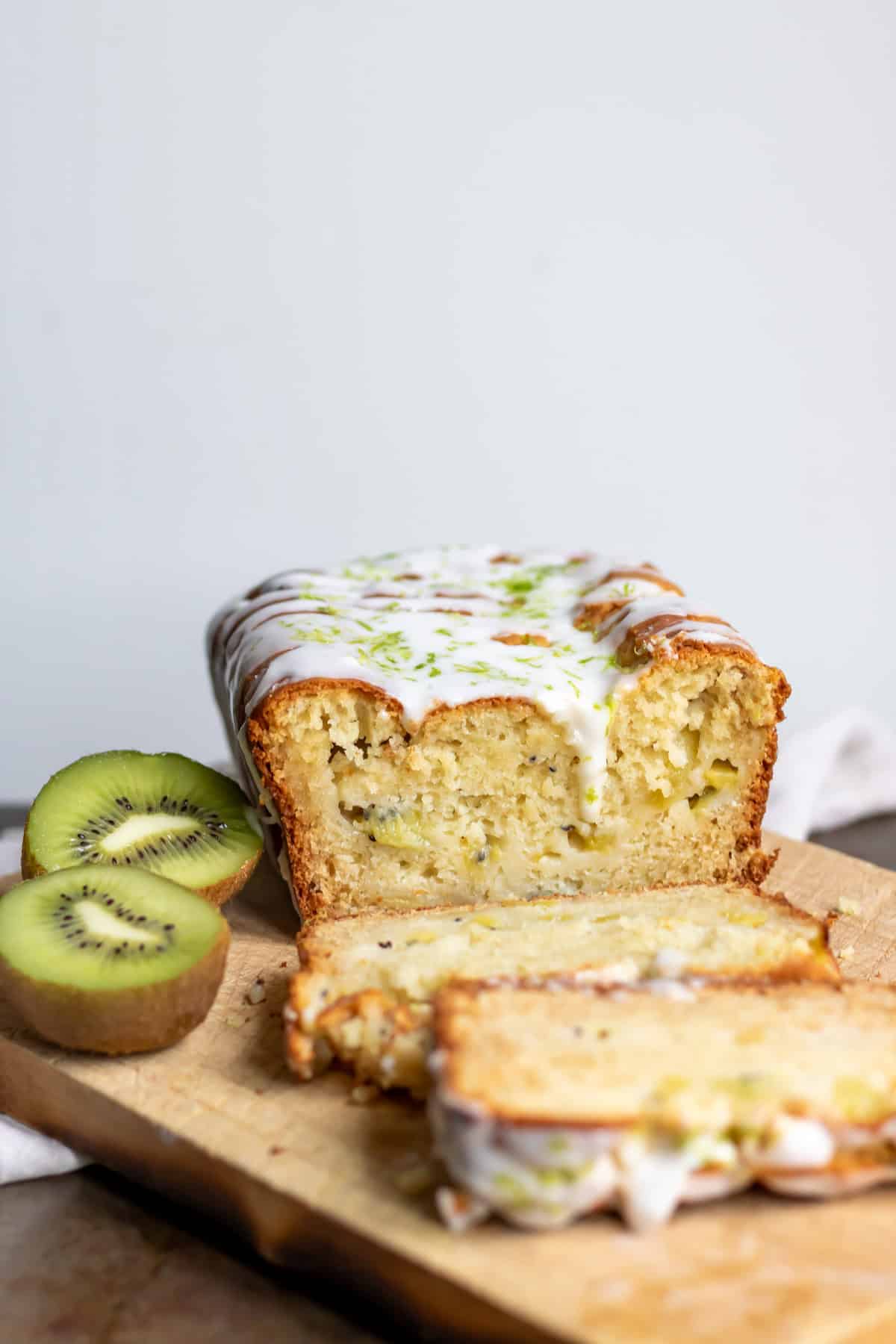 Side view of the sliced kiwi cake with lime drizzle.