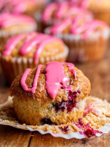 Close up of a frozen berry muffin on a table.