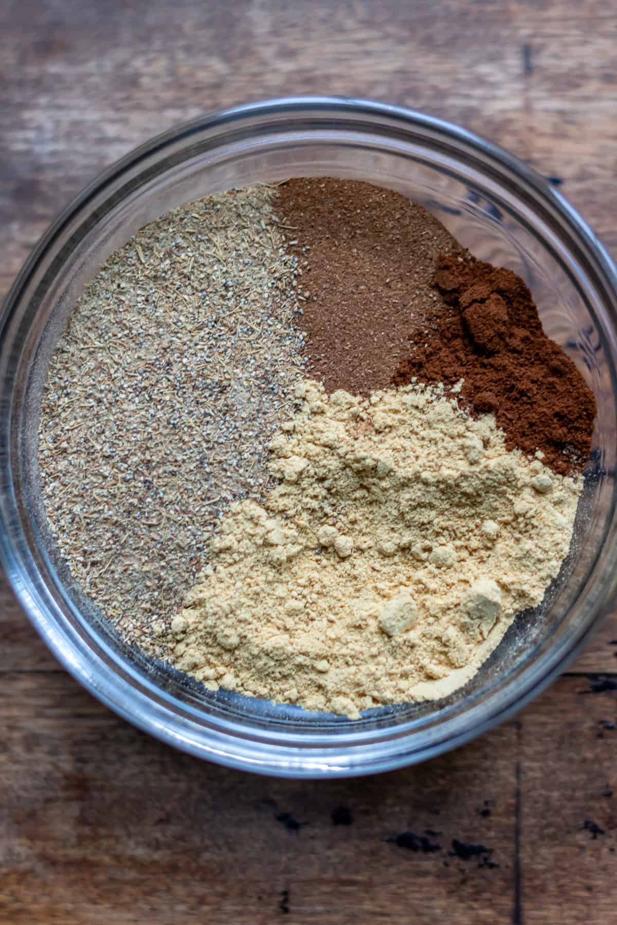 Spices for Yemeni sweet hawaij in a bowl.