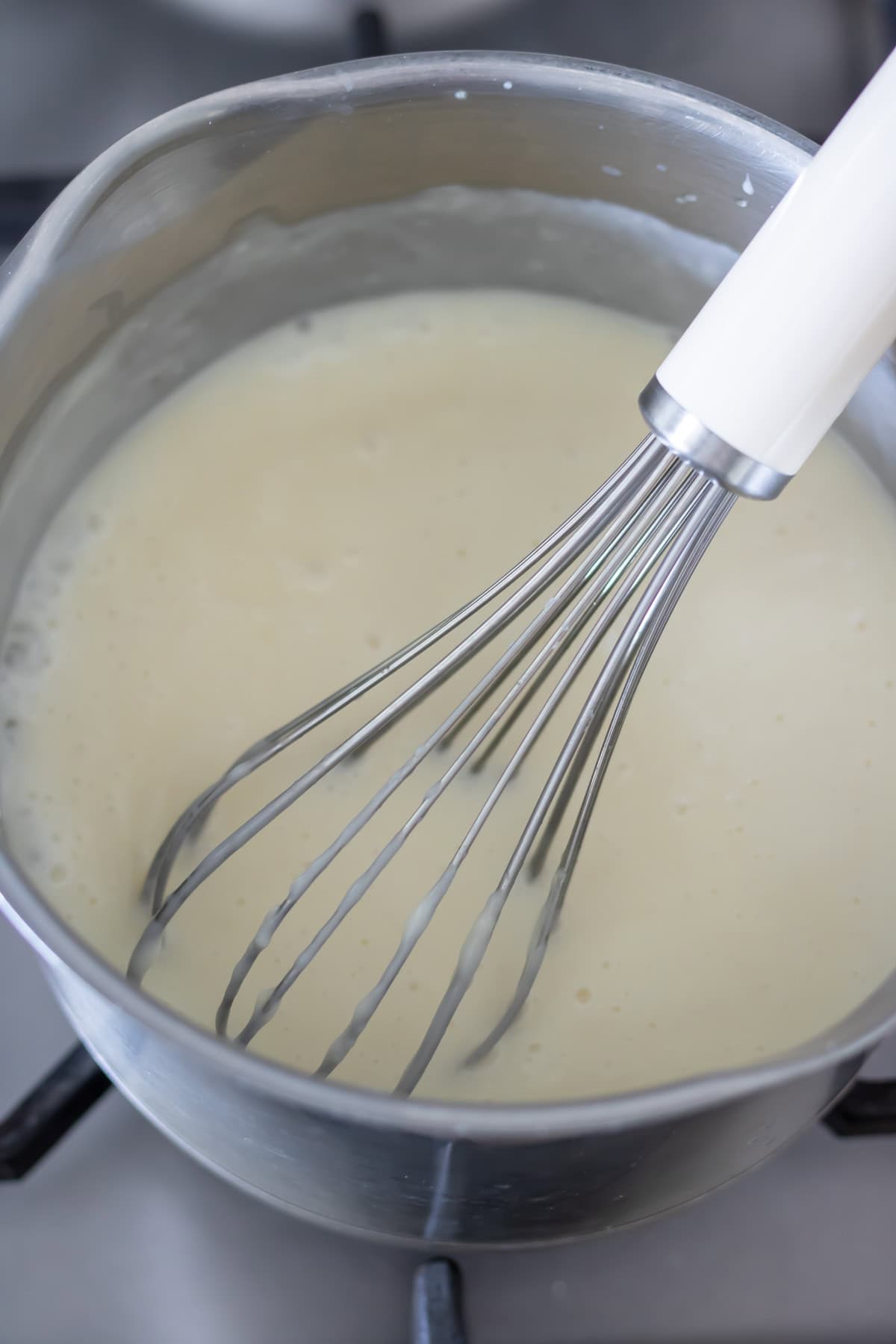 Whisking the white sauce.