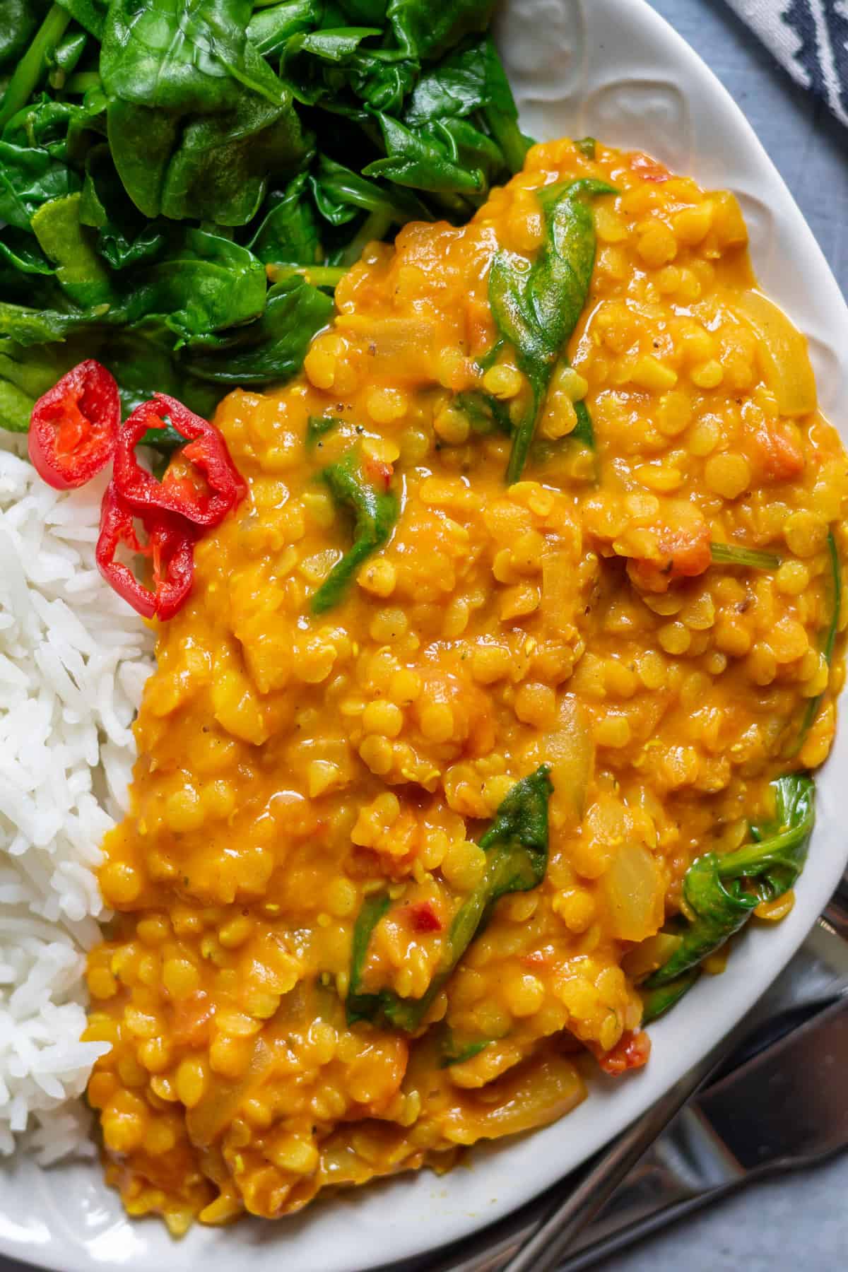 Close up of red lentil dhal on a plate.