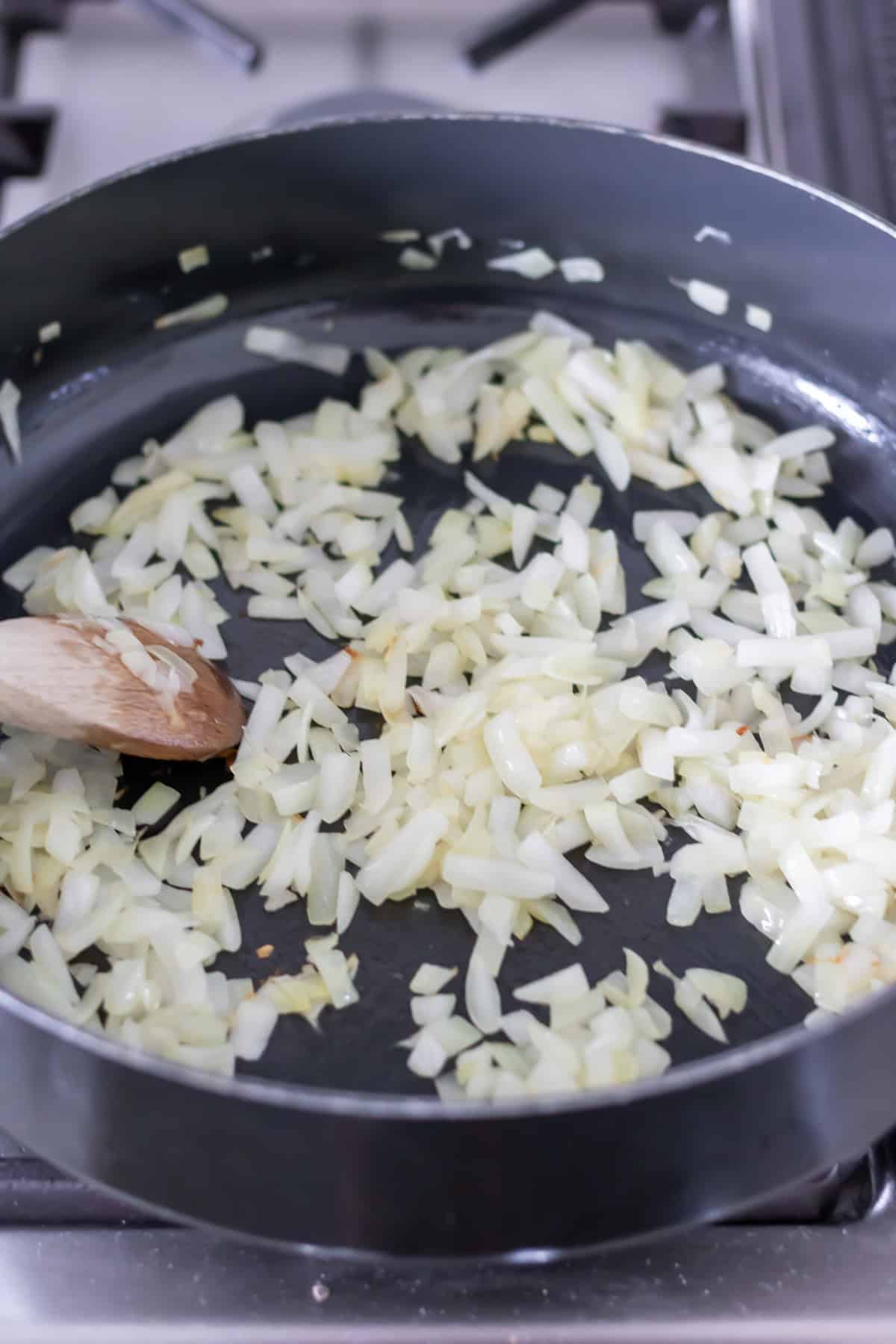 A pan with onions cooking on it.