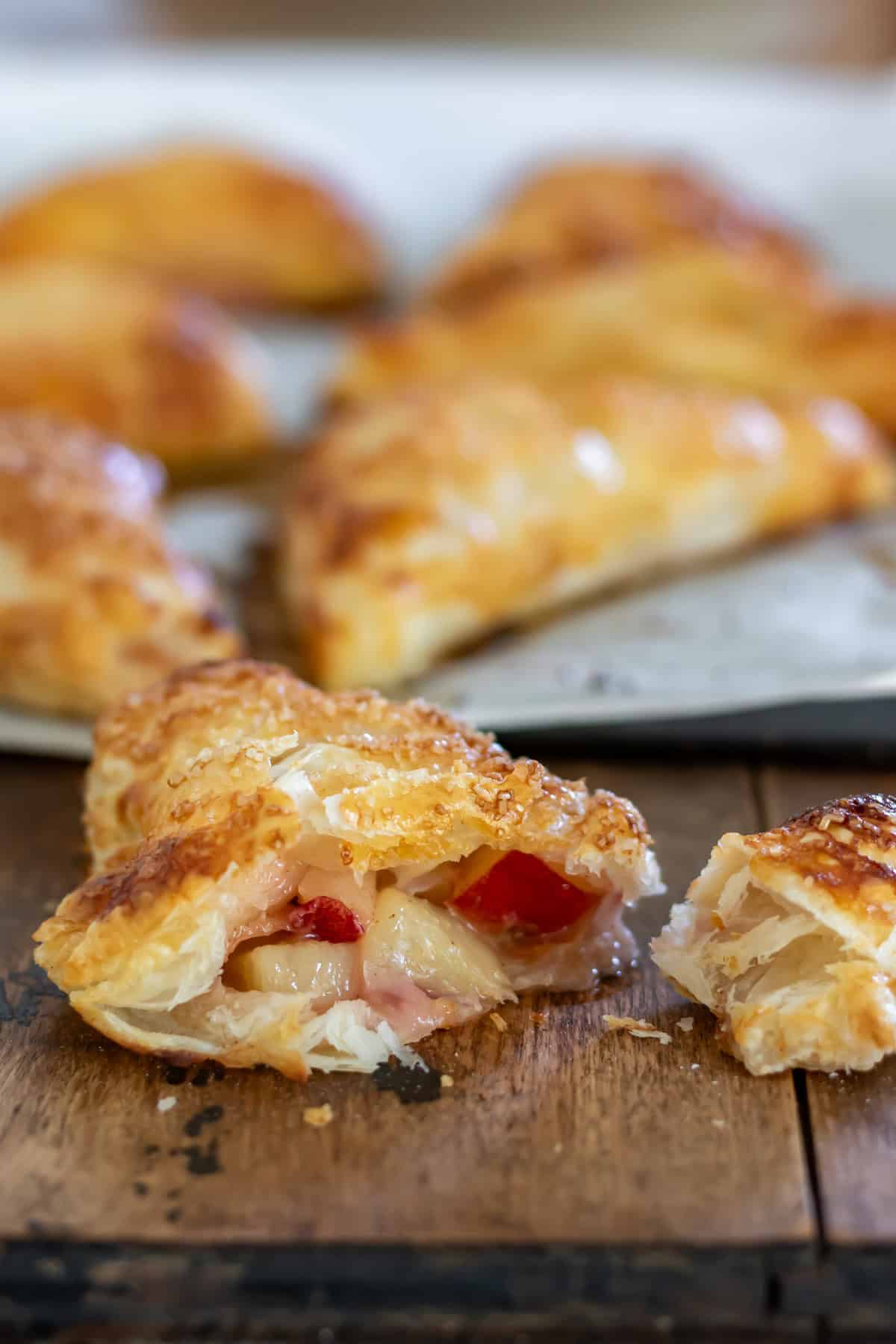Side view of a nectarine turnover with a bite out, showing the filling.