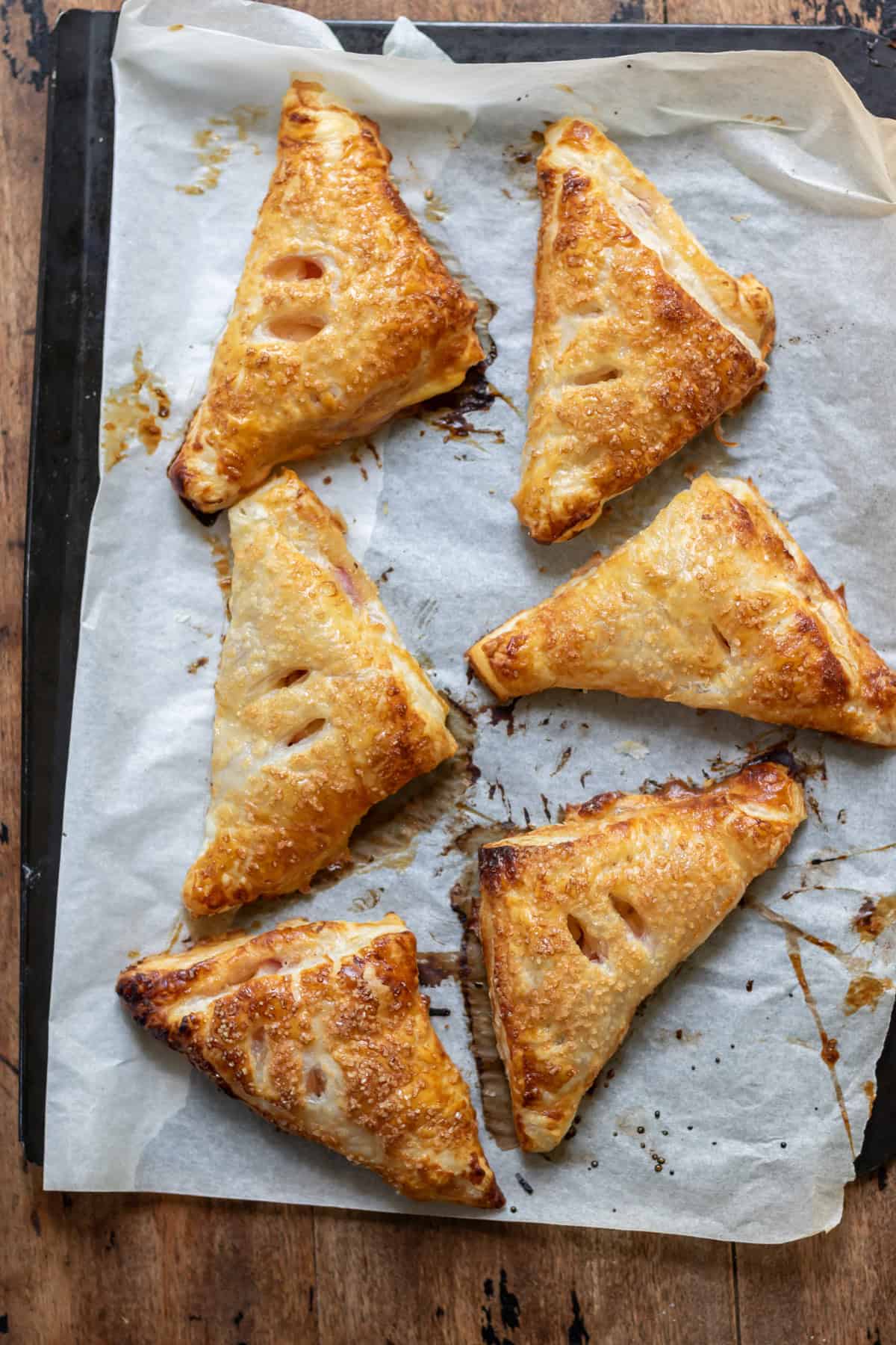 Baked nectarine turnovers on a baking sheet.