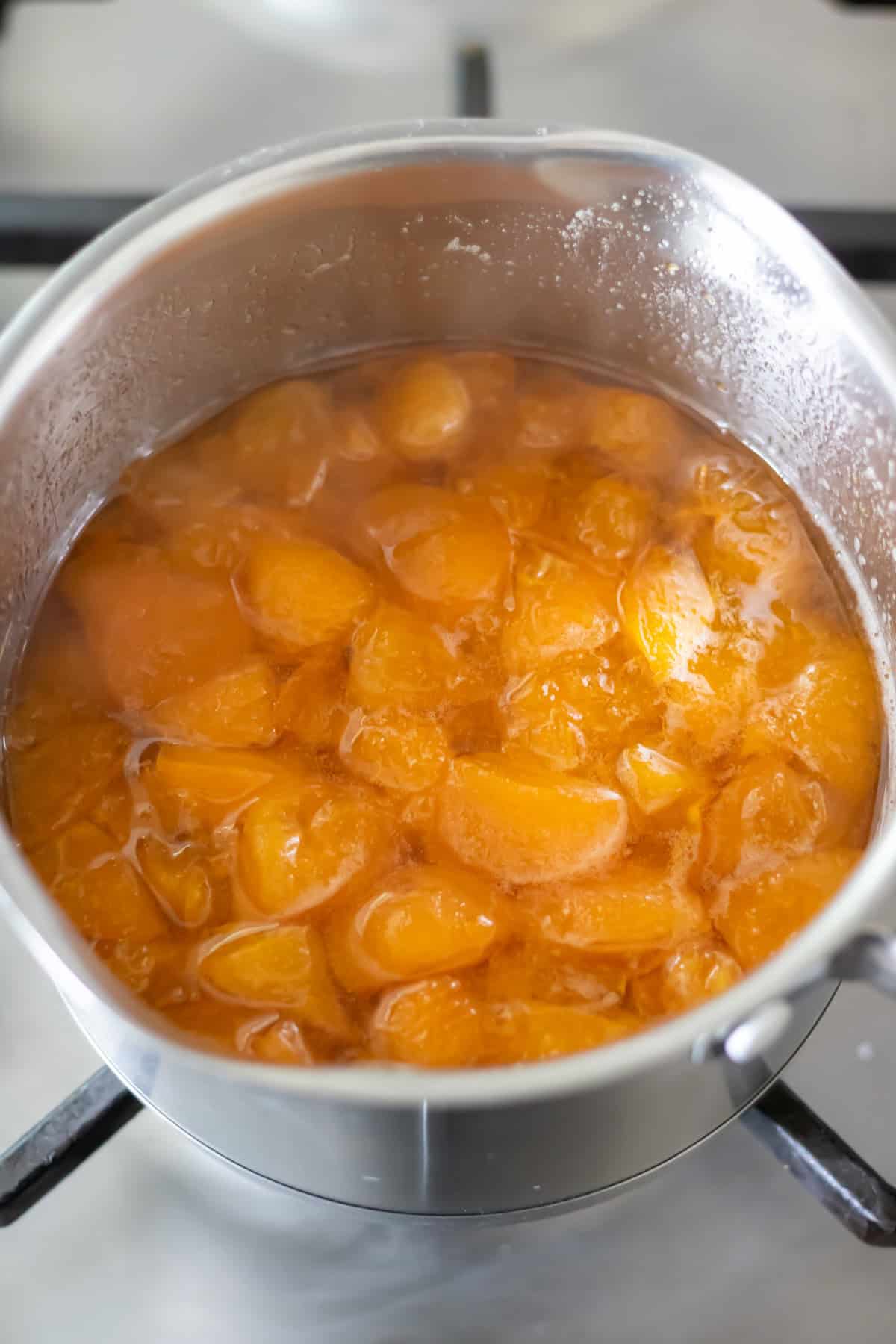 Cooked apricots in a pot.
