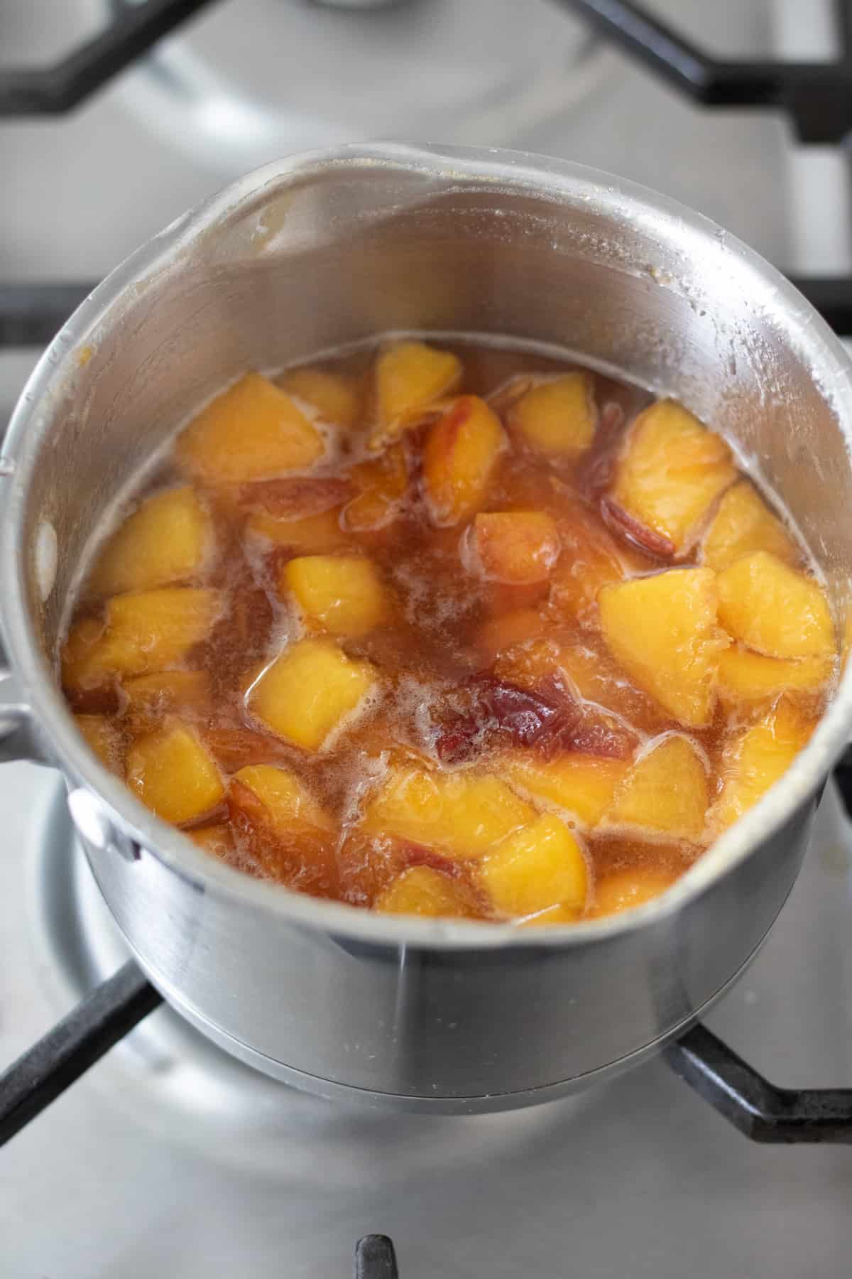 Simmering nectarine syrup.