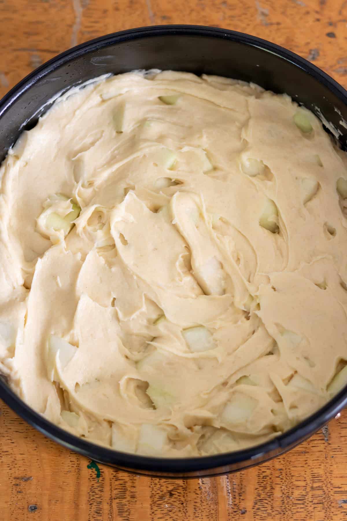 Spreading the batter evenly into the cake pan.