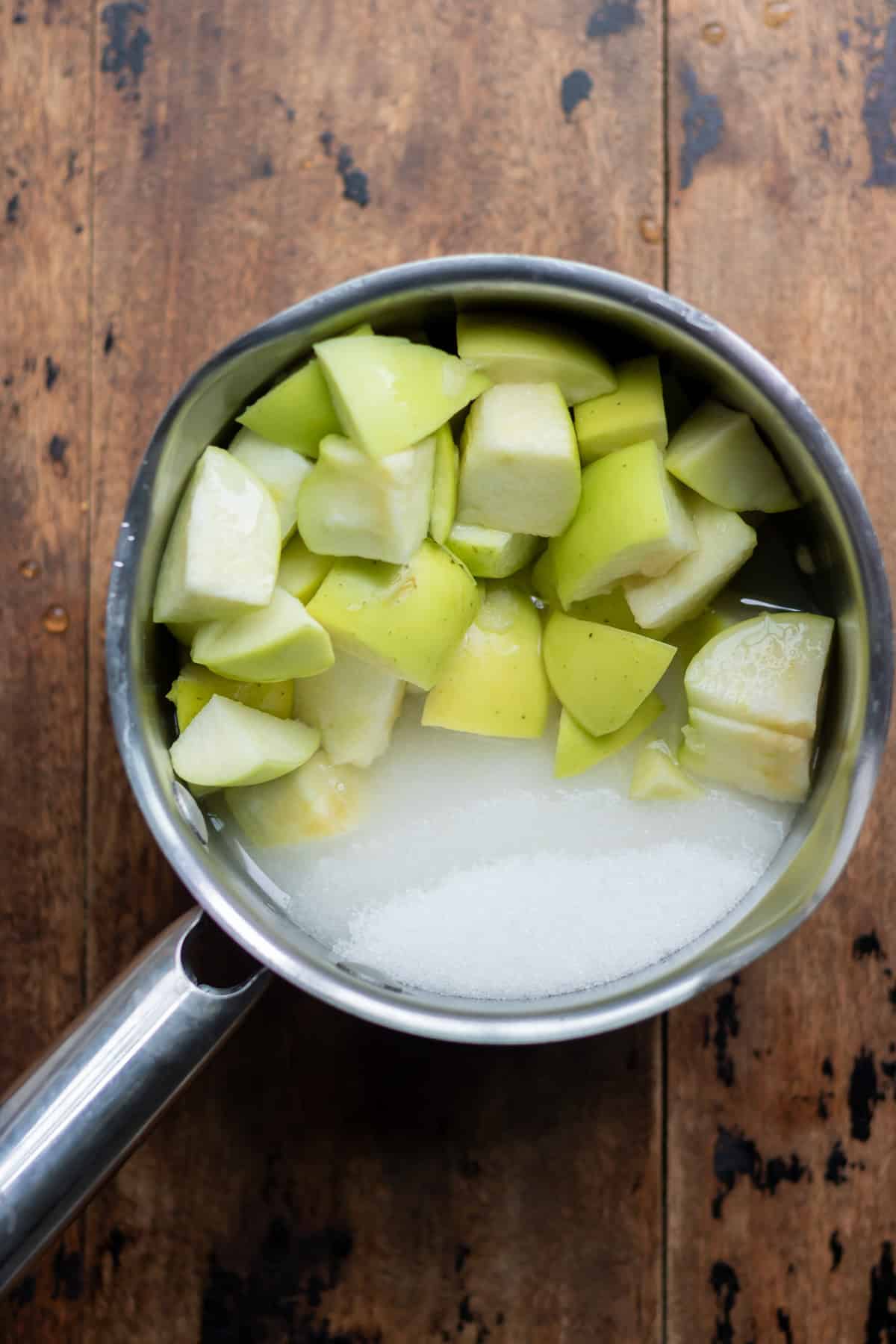 Apples, sugar and water in a saucepan.