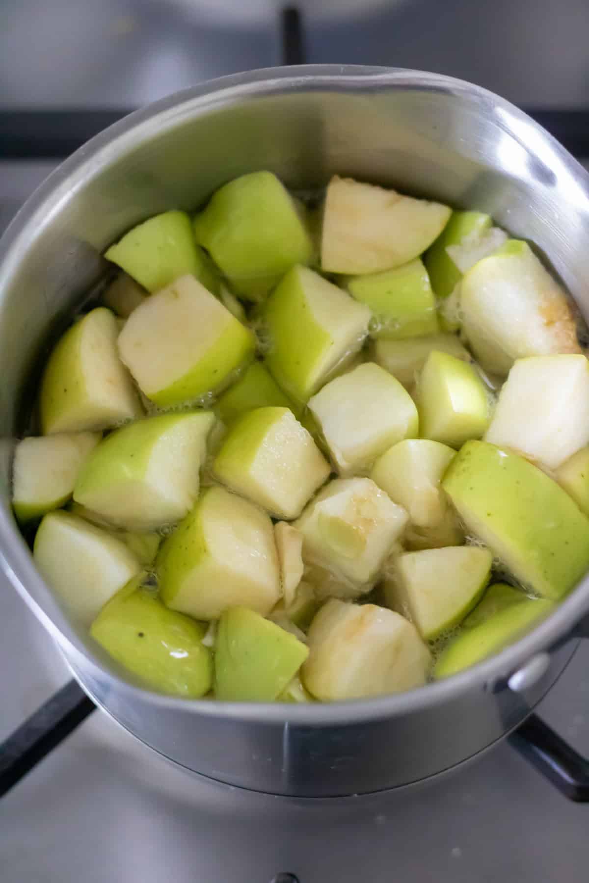 Simmering apples in sugar water.
