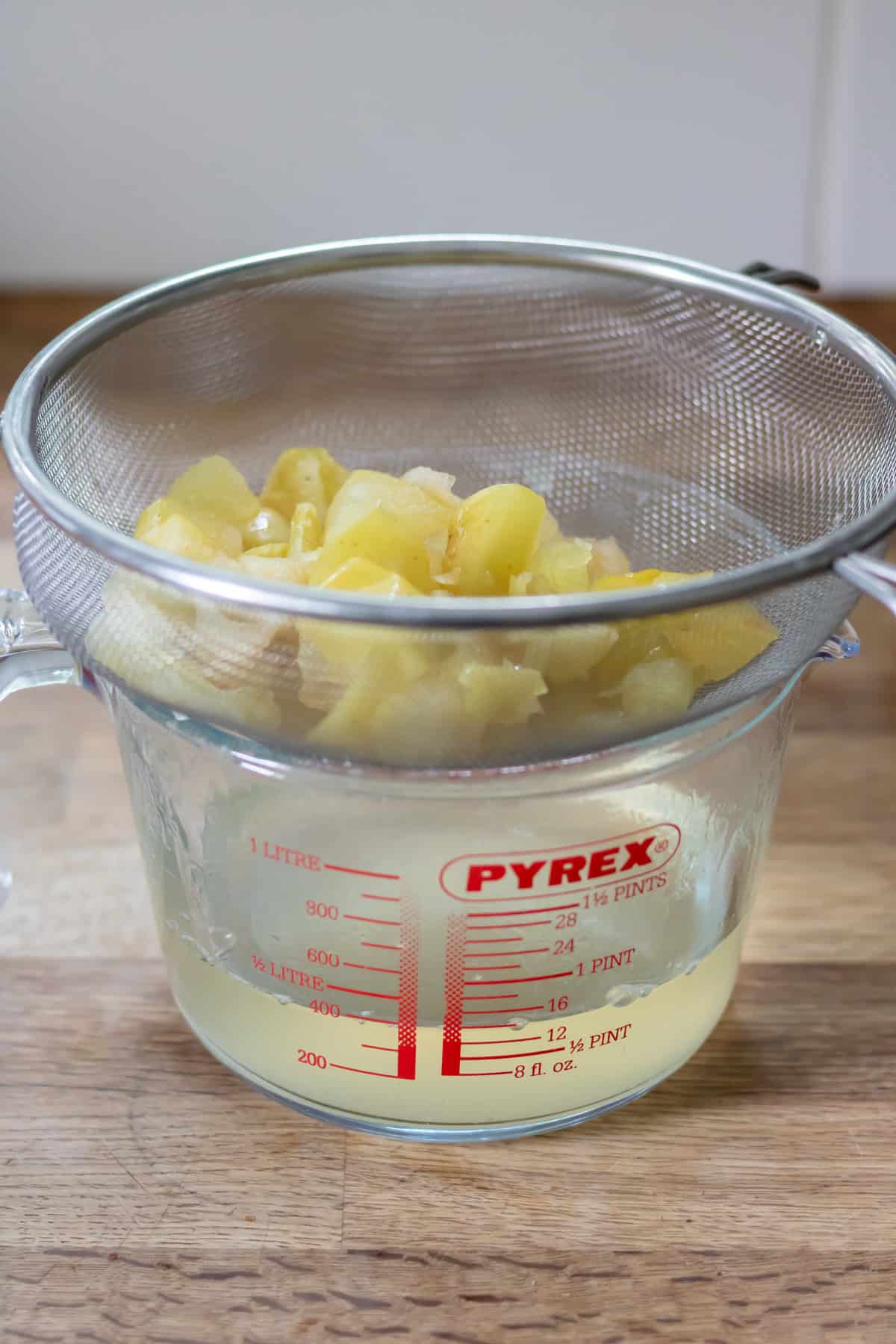 Straining out the apples from the apple syrup.