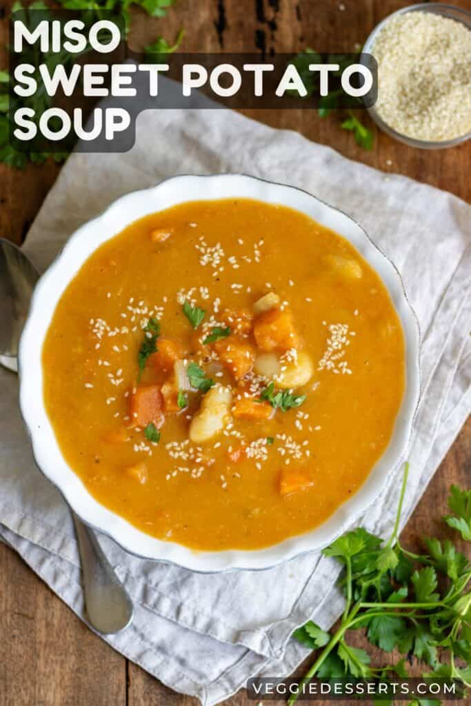 Bowl of soup on a table with text: Miso Sweet Potato Soup.