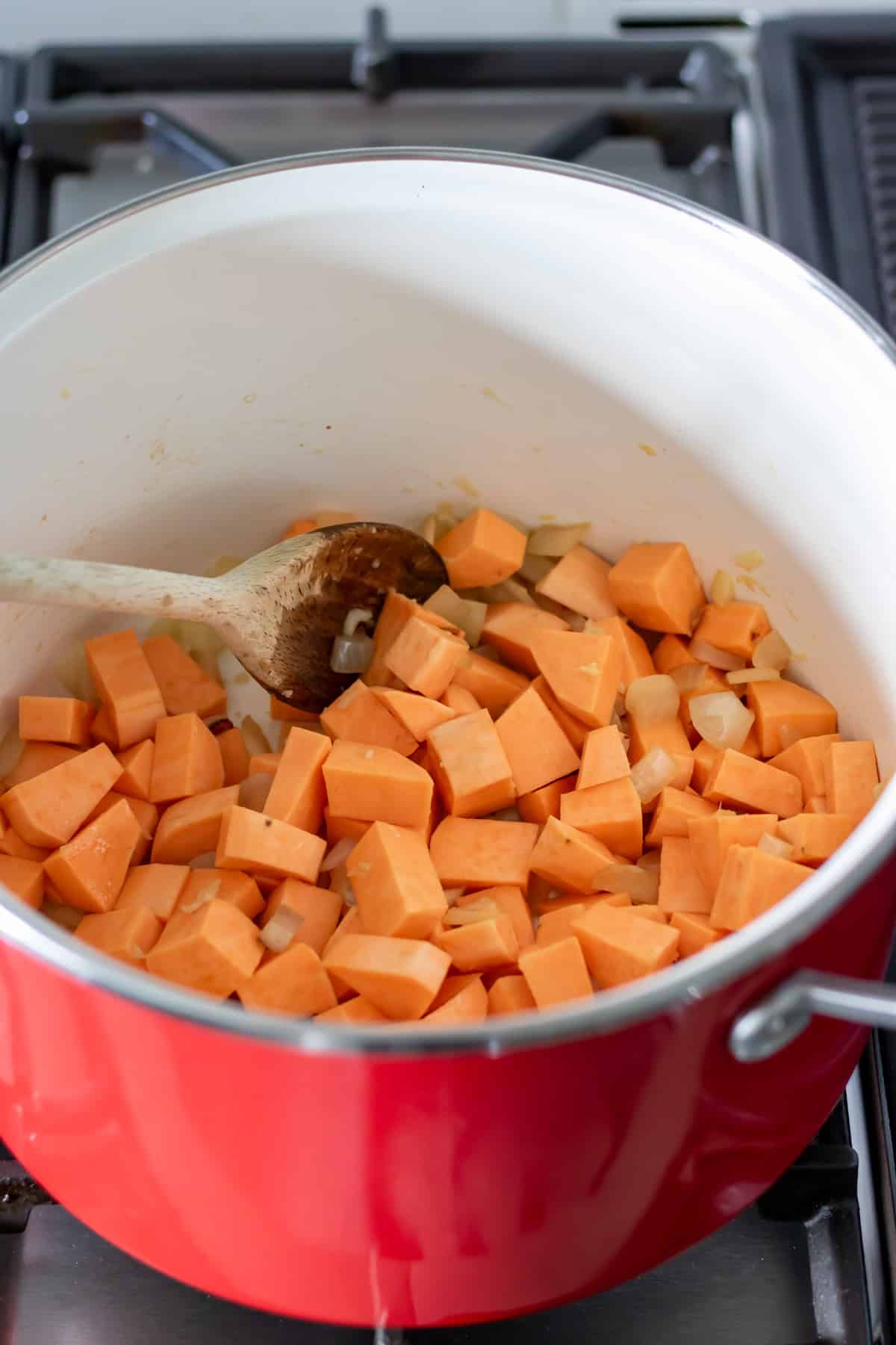 Sweet potatoes and carrots added to the cooked onions.