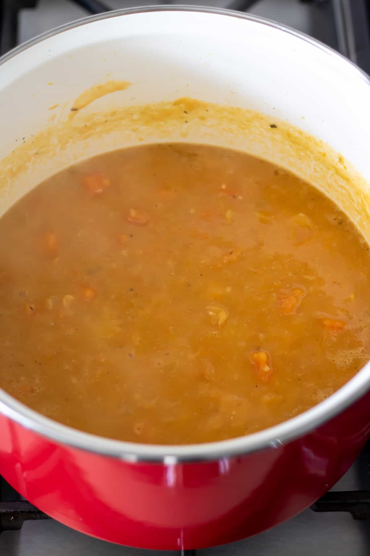 Half blended soup in a pot.