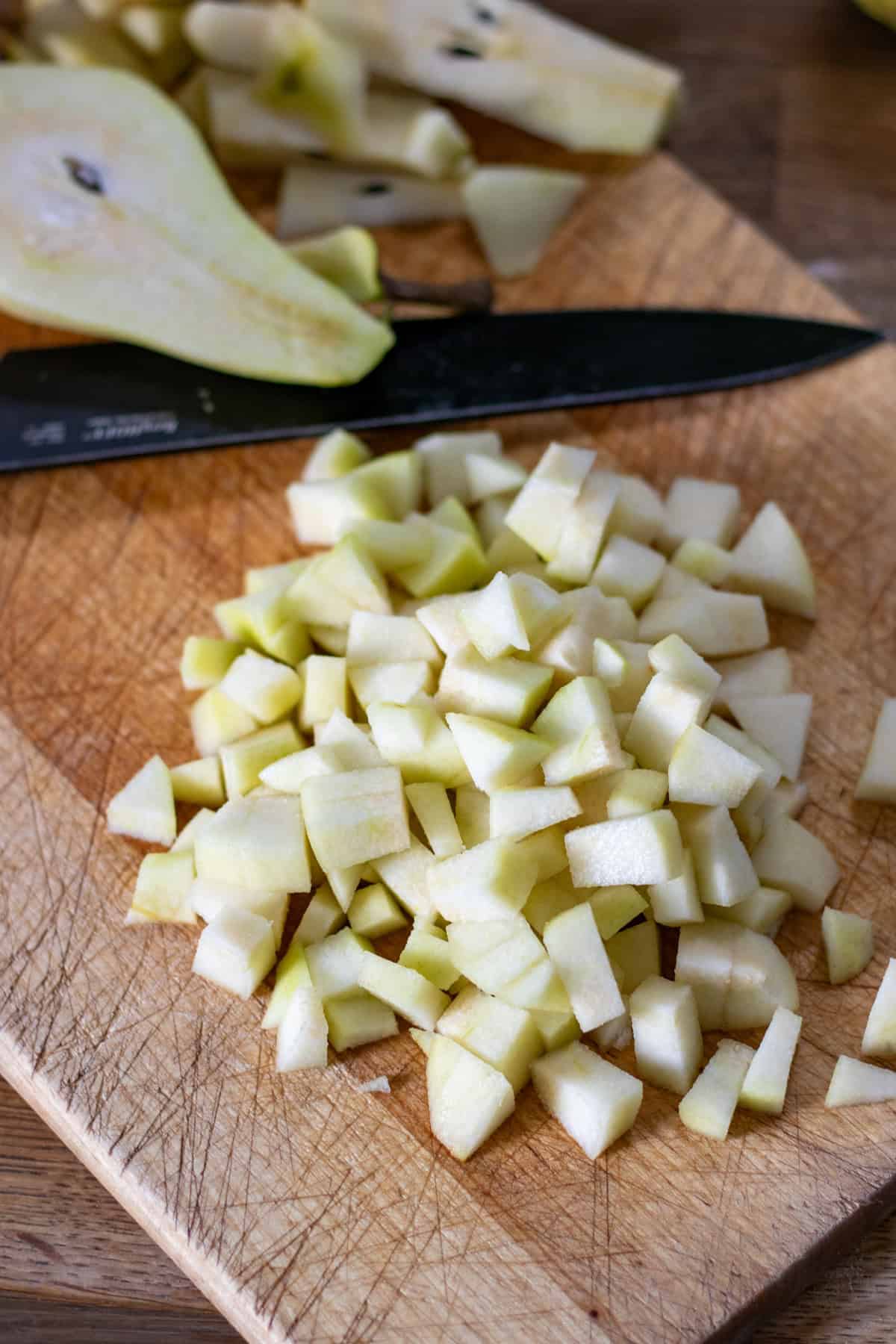 Chopping the peeled and cored pears.