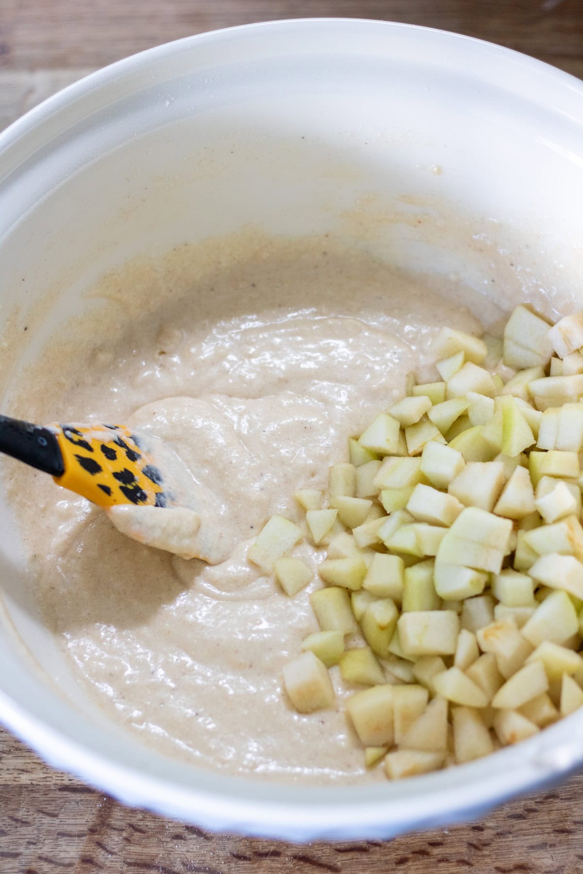 Folding the pears into the muffin batter.
