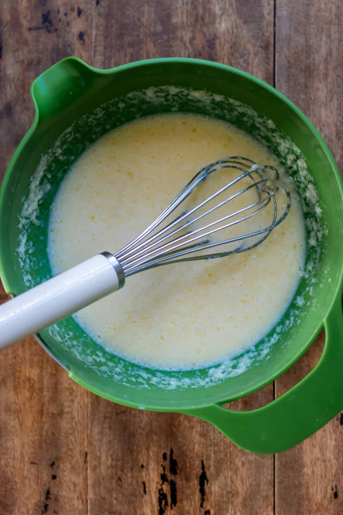 Whisking the wet ingredients in a bowl.
