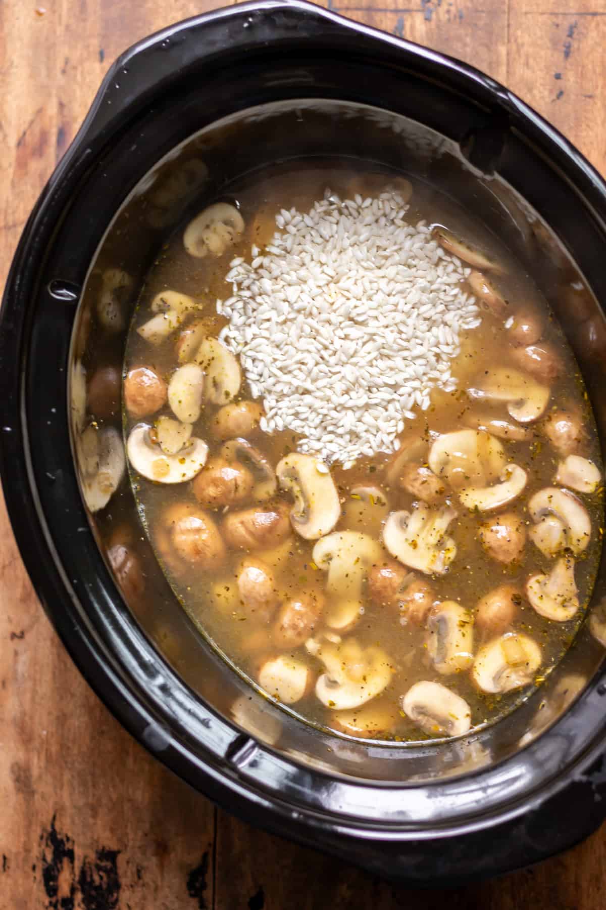 Stock and rice added to the slow cooker.