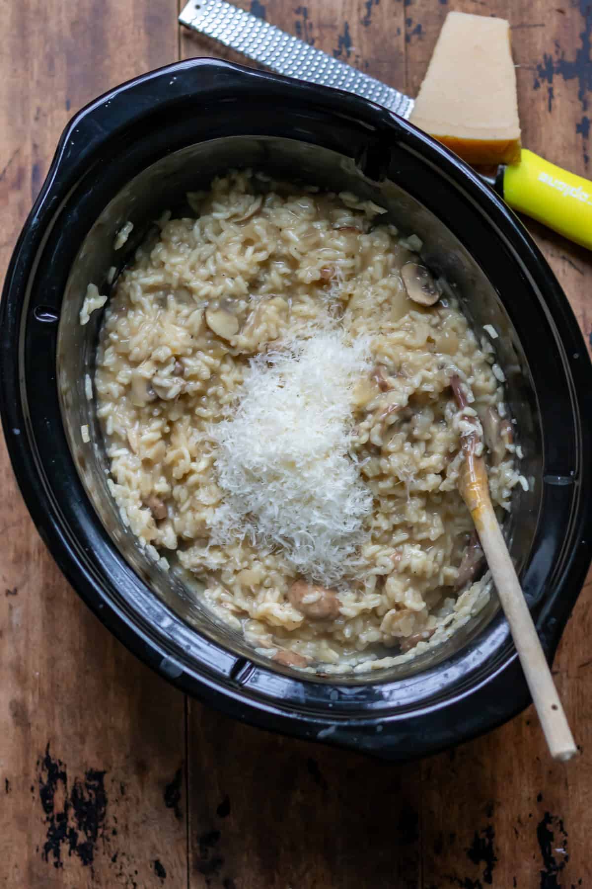 Stirring the parmesan into the mushroom risotto.