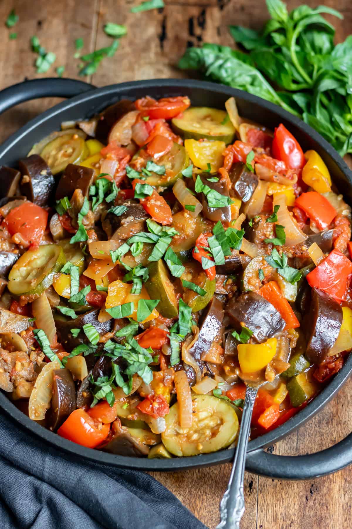 A spoon in a dish of crockpot ratatouille.