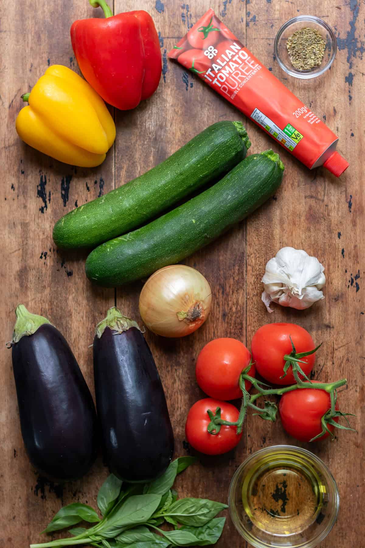 Ingredients for ratatouille on a wooden table.