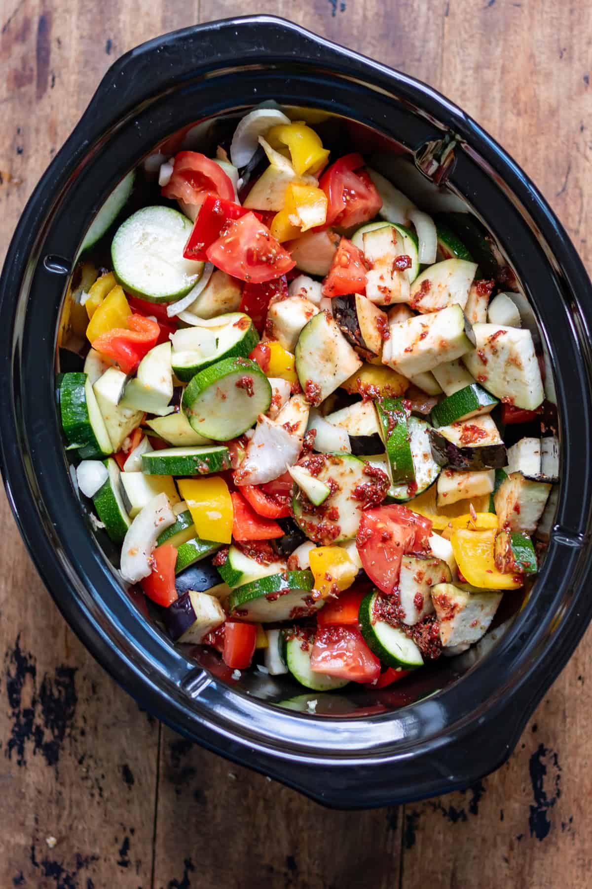 Herb tomato sauce stirring into the vegetables.
