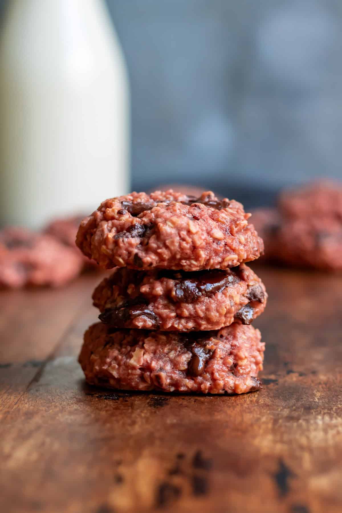 A stack of chocolate chunk beetroot cookies on a wooden table.