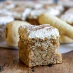 Side view of a slice of parsnip cake with nutmeg frosting.
