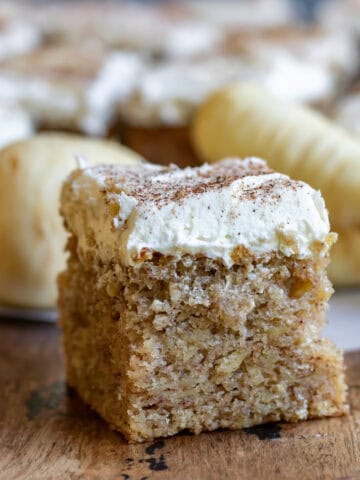 Side view of a slice of parsnip cake with nutmeg frosting.