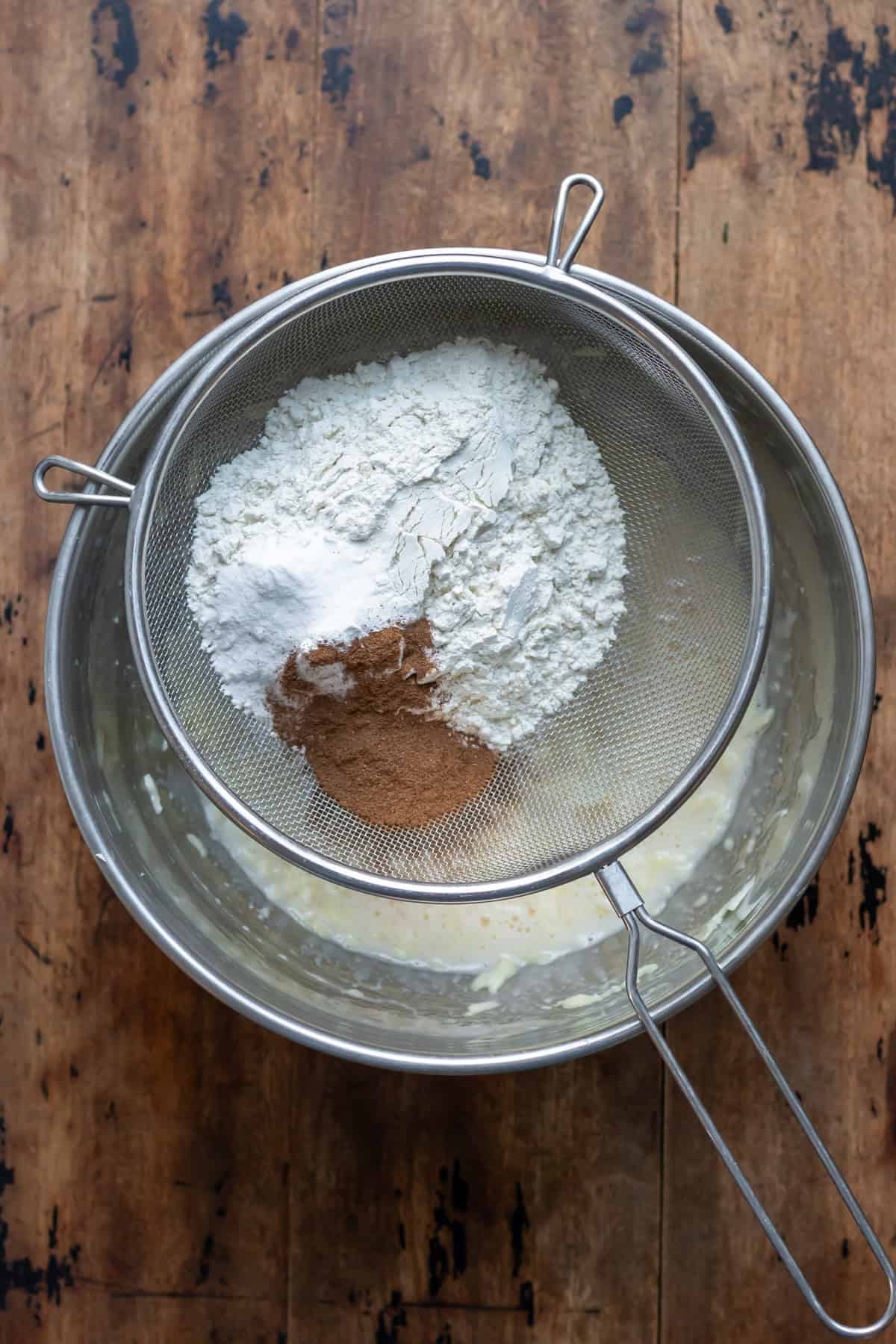 Sifting in the flour, baking powder and spices.