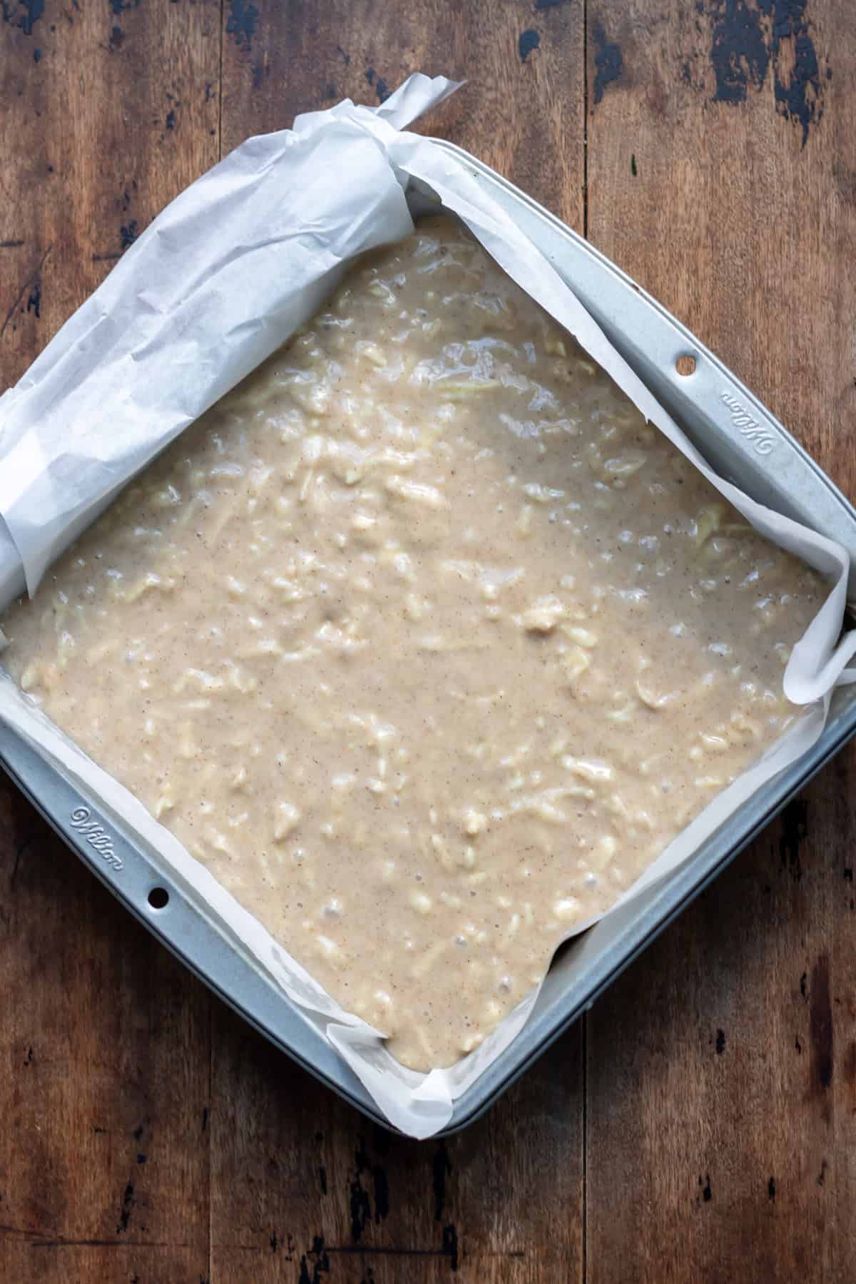 Parsnip cake batter in an 8" square baking pan.