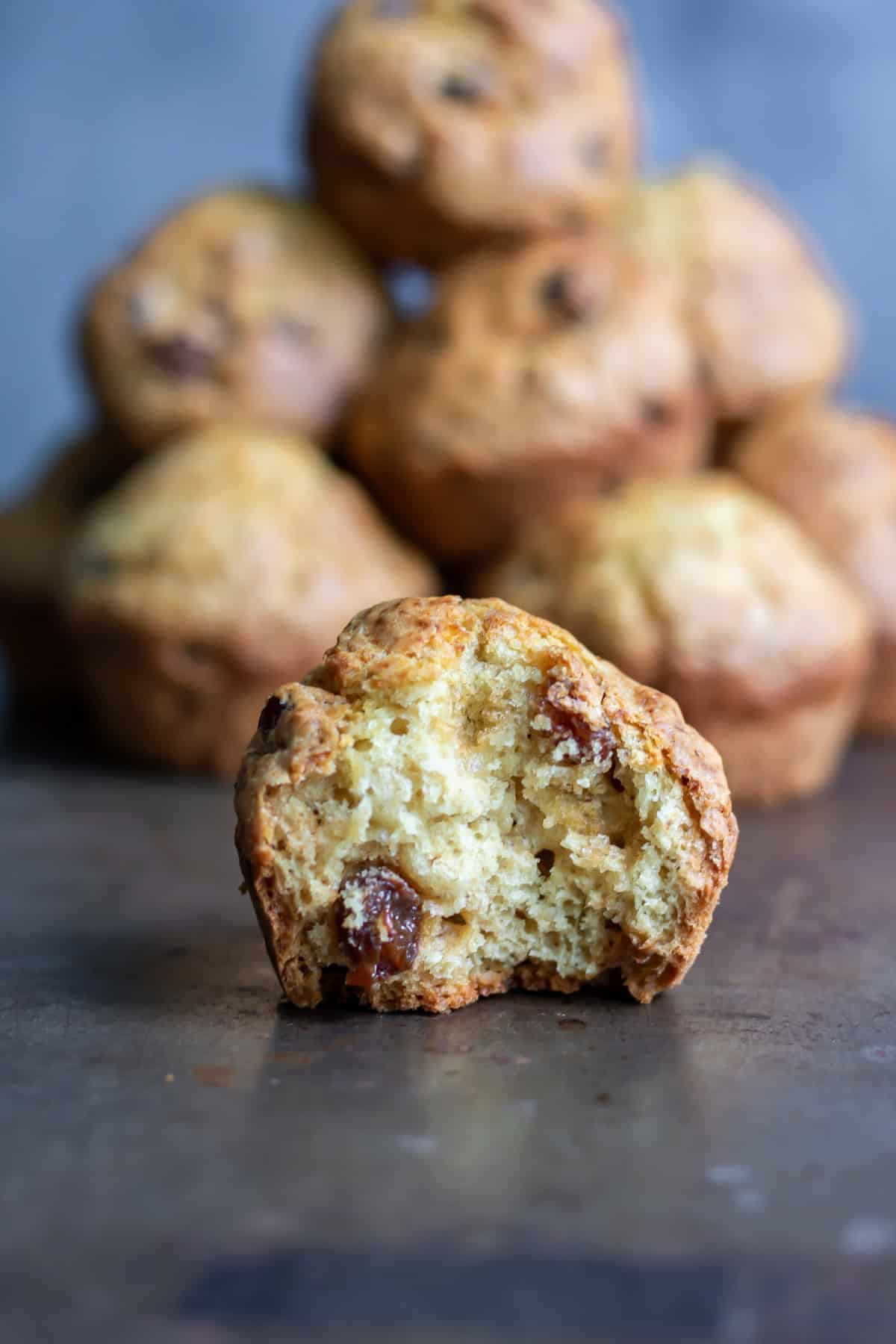 A raisin soda bread muffin with a bite out.