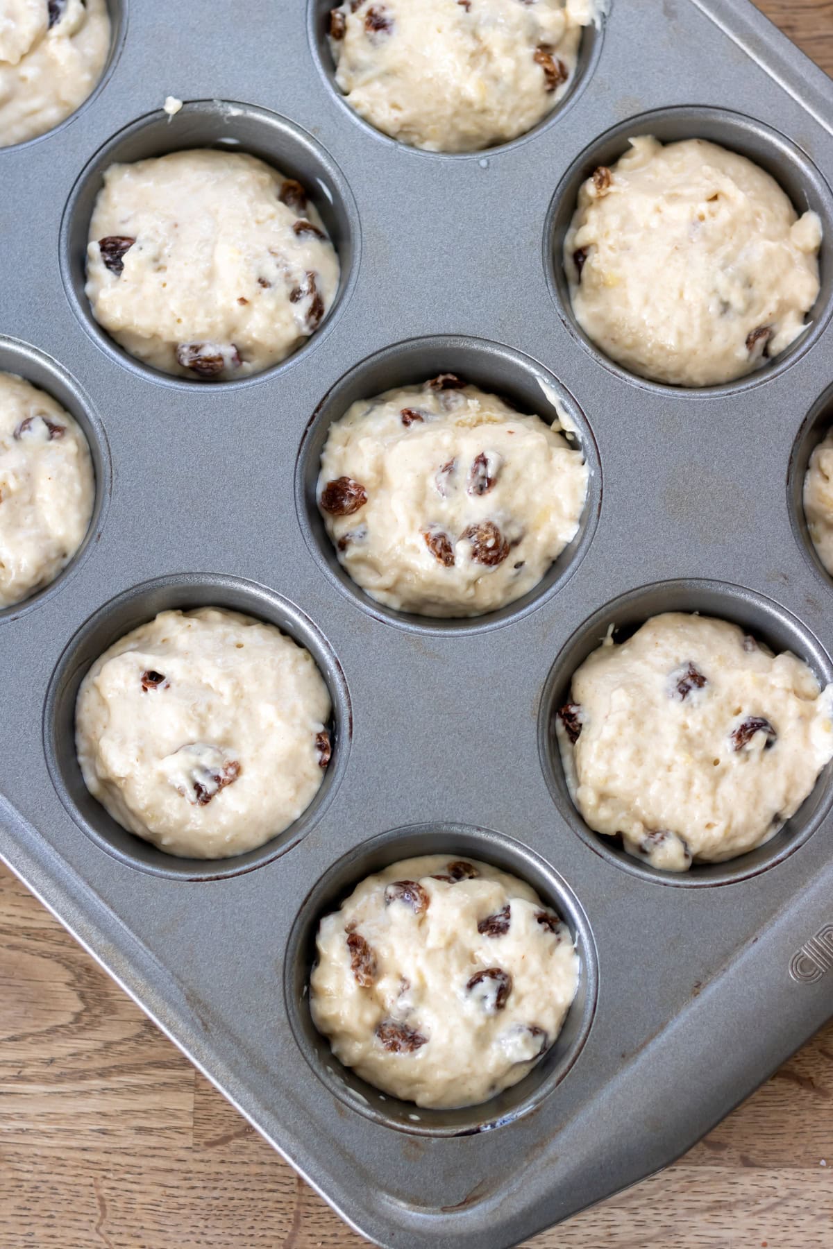 Muffin batter in the muffin pan.