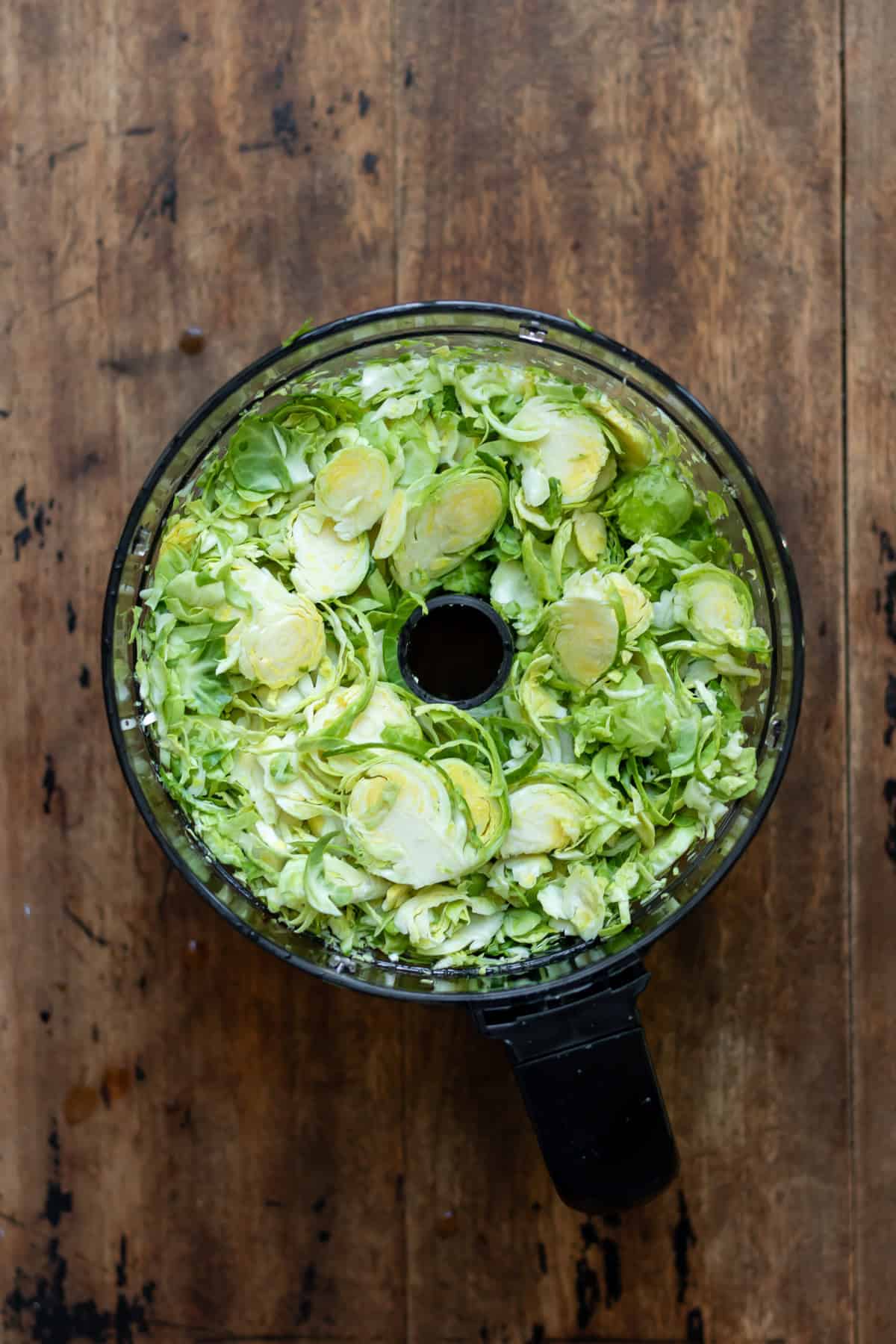 Shredded brussels sprouts in a food processor.