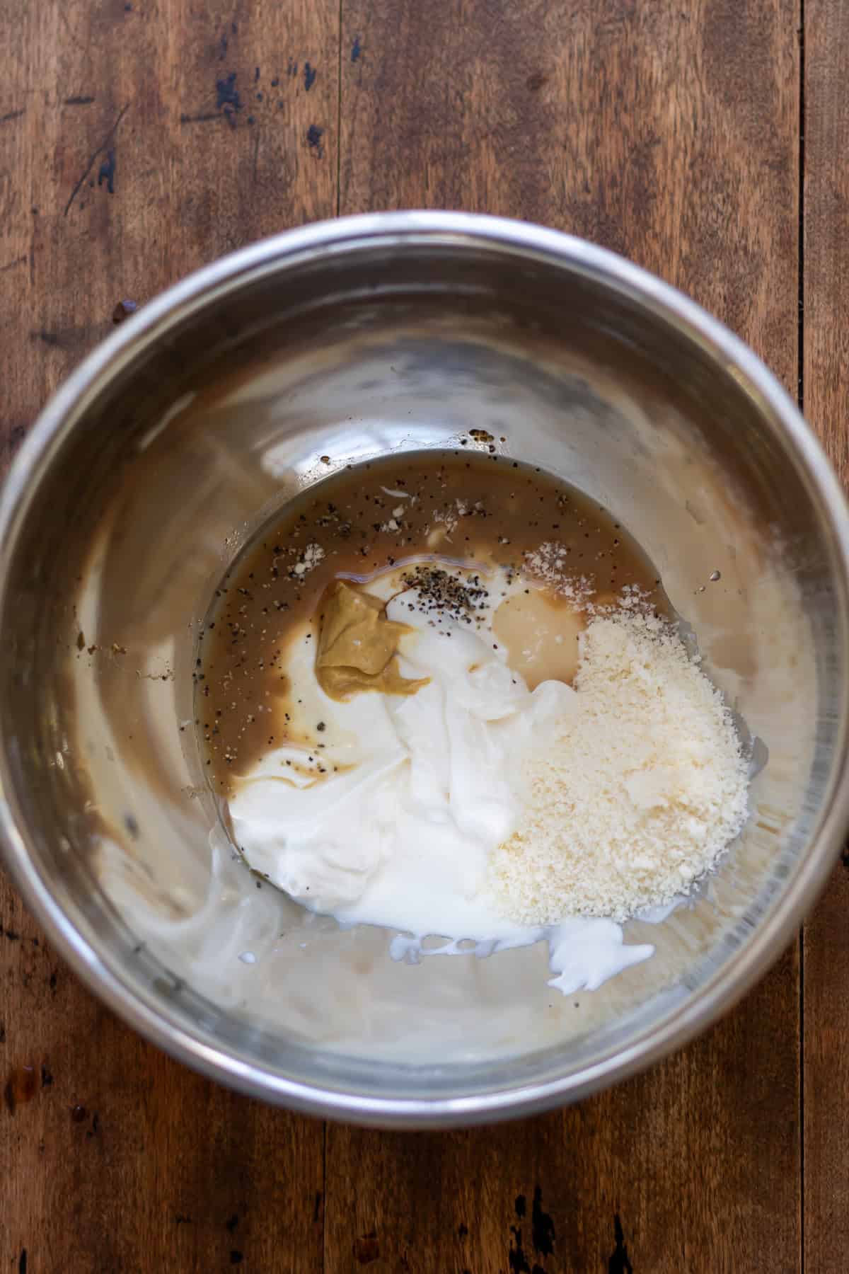 Caesar dressing ingredients in a bowl.