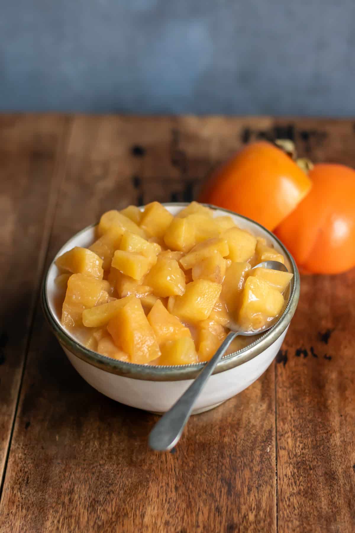 Side view of a bowl of persimmon compote.
