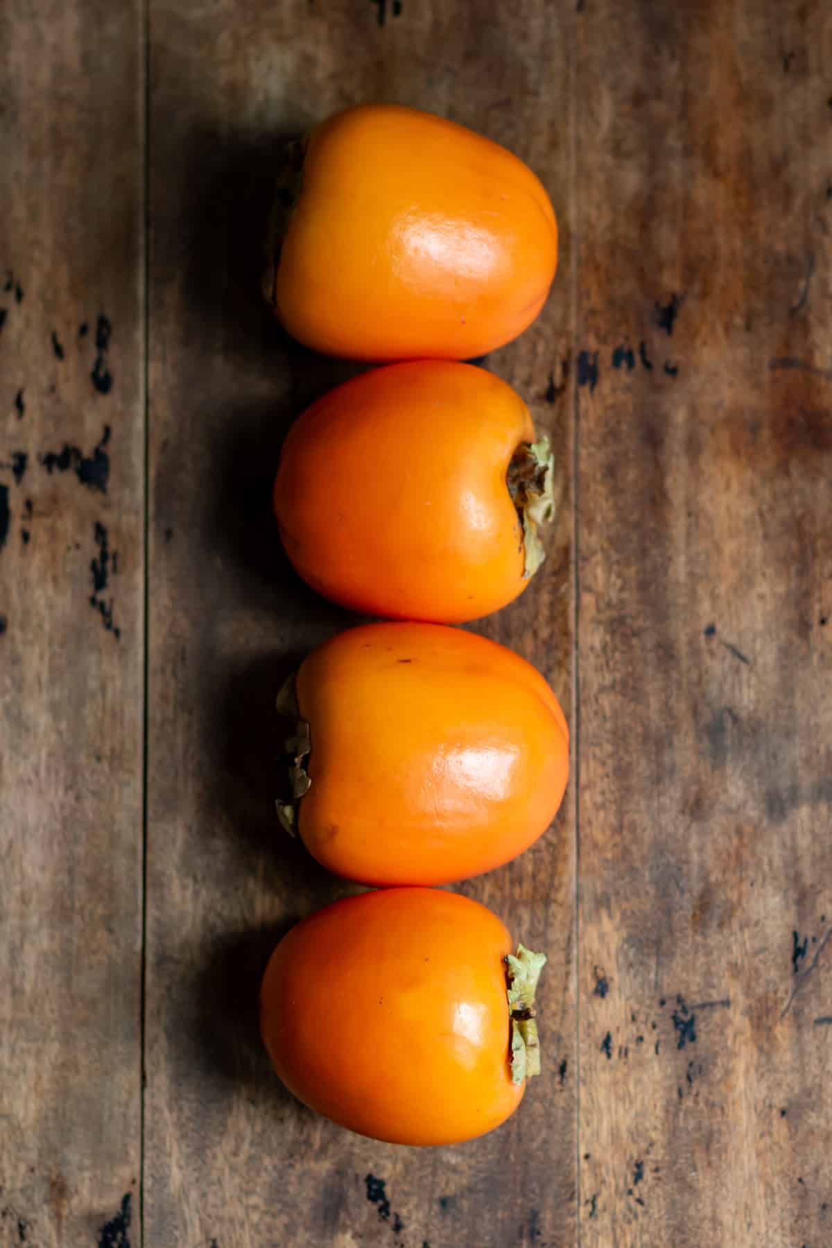A row of ripe persimmons.