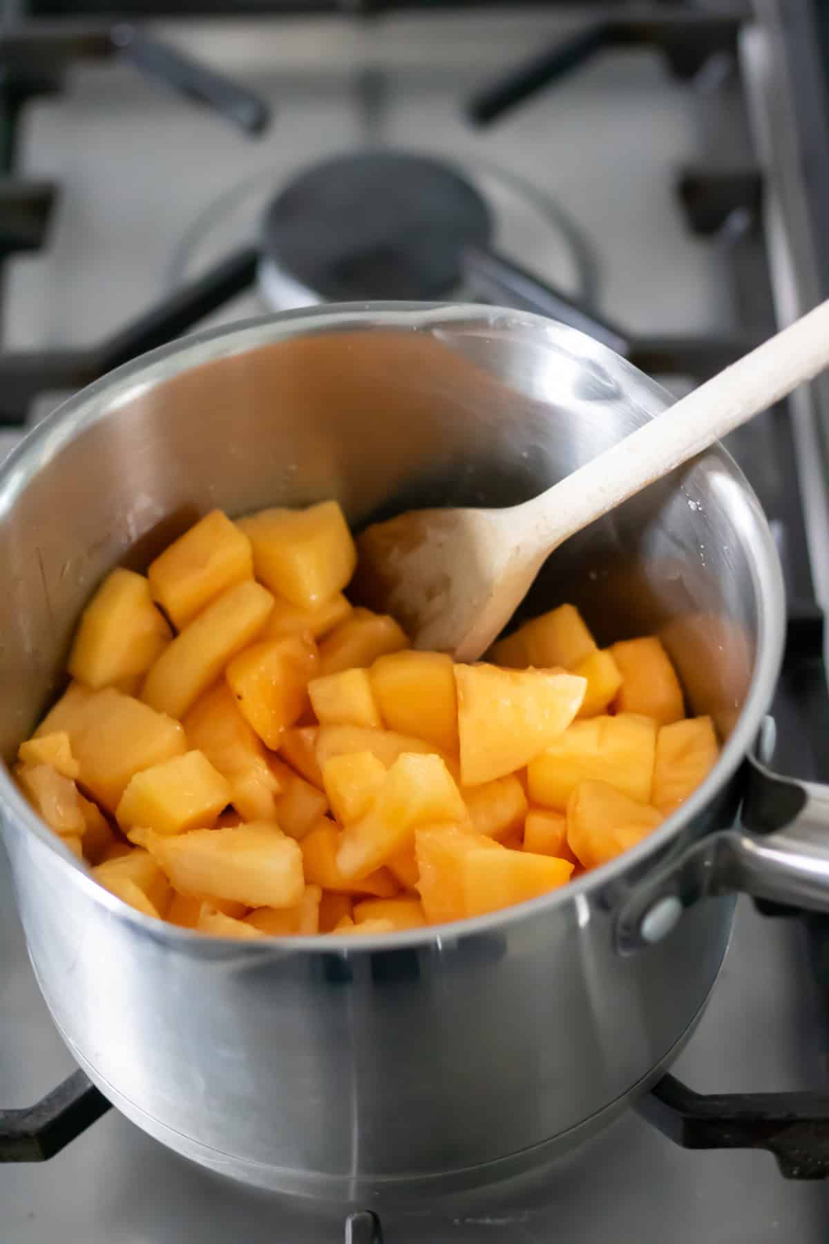 Stirring the pot of persimmons.